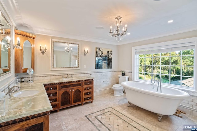 bathroom featuring toilet, tile walls, and ornamental molding