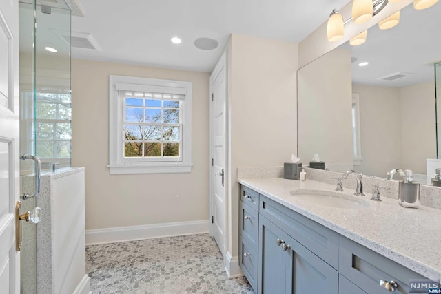 bathroom with tile patterned flooring, vanity, and an enclosed shower