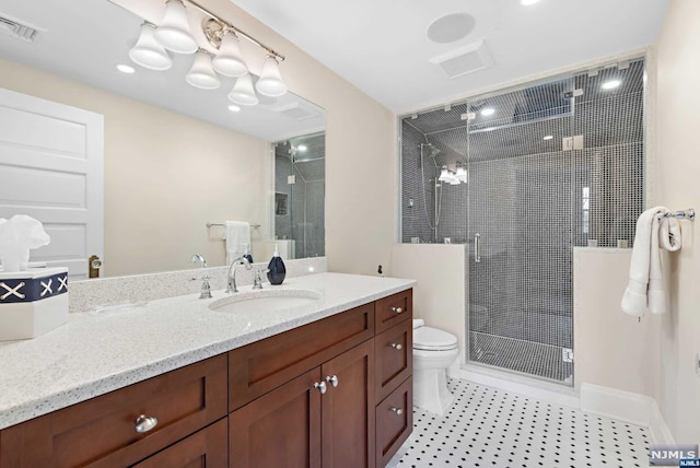 bathroom featuring vanity, toilet, and a shower with door