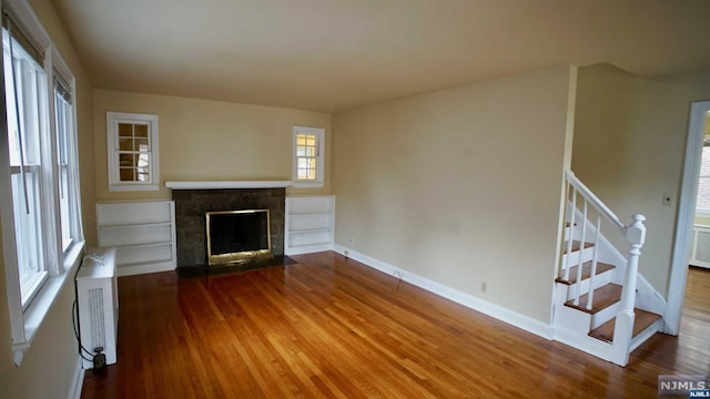 unfurnished living room with hardwood / wood-style flooring