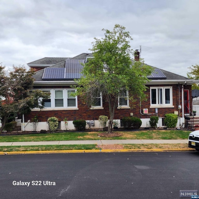 view of front of house featuring solar panels