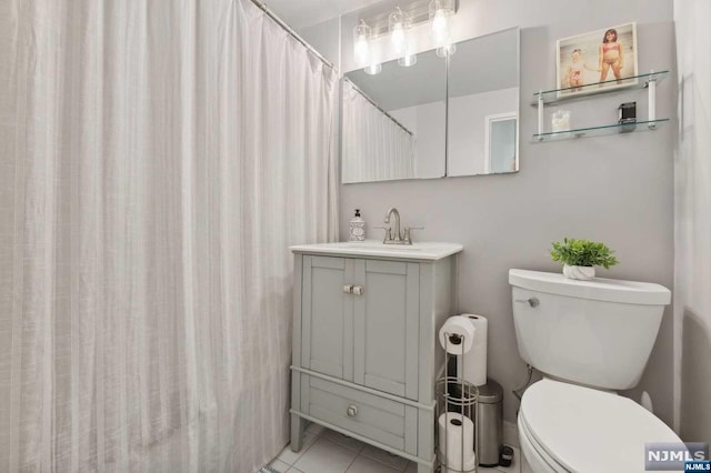 bathroom with tile patterned flooring, vanity, curtained shower, and toilet