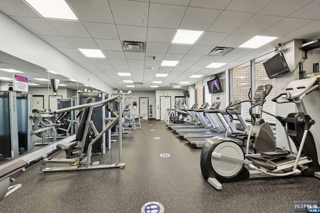 exercise room with a paneled ceiling