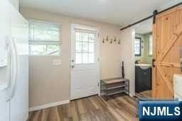 doorway featuring a barn door and hardwood / wood-style flooring