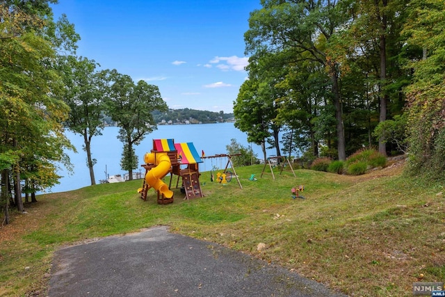 view of play area featuring a yard and a water view