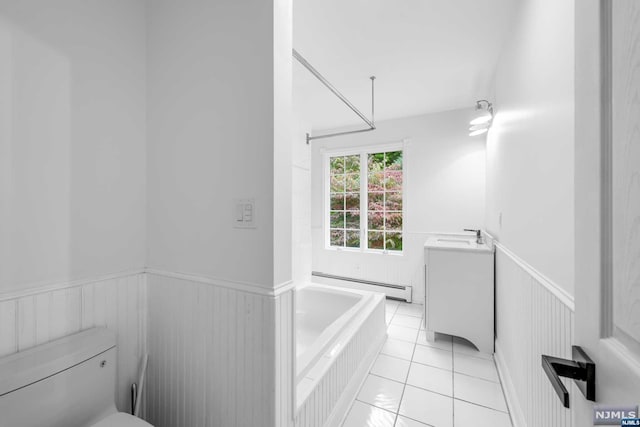 bathroom featuring tile patterned floors, a washtub, vanity, a baseboard heating unit, and toilet