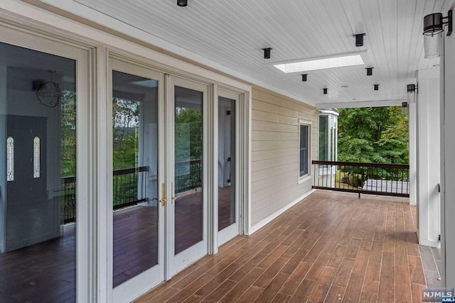 wooden terrace with french doors and a porch