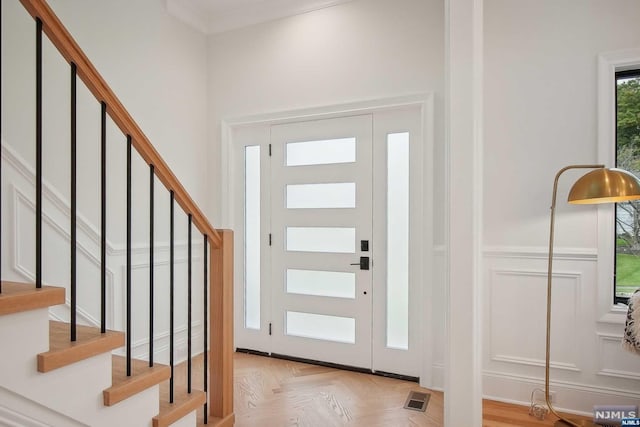 foyer entrance featuring light parquet flooring