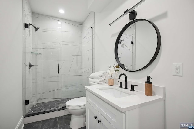 bathroom featuring tile patterned flooring, vanity, toilet, and a shower with door