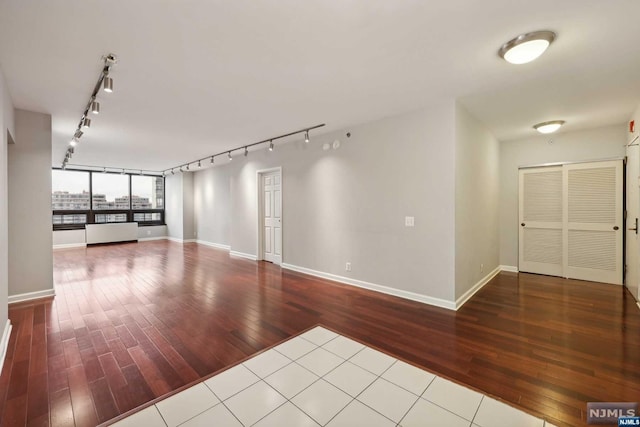 interior space featuring wood-type flooring and rail lighting