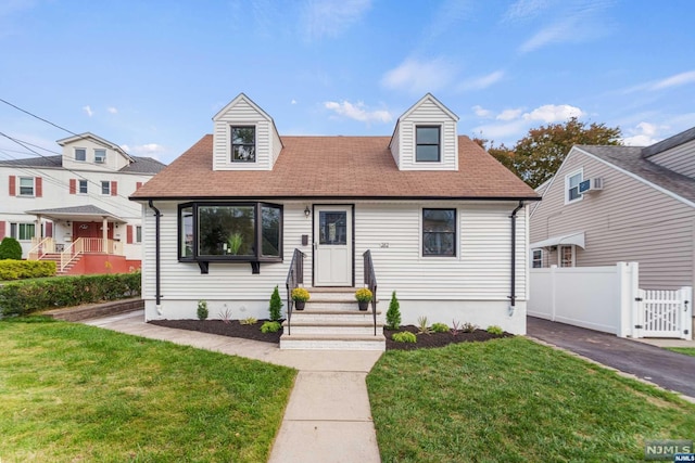 new england style home with a front lawn