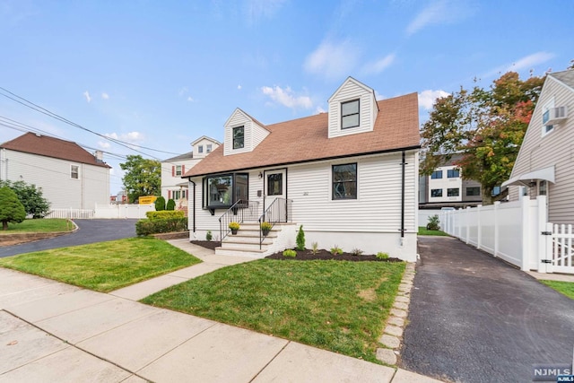 cape cod home with a front lawn