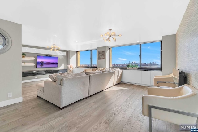 living room with a chandelier and light hardwood / wood-style floors