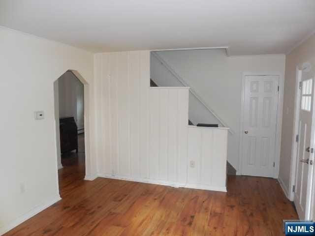 empty room with hardwood / wood-style flooring