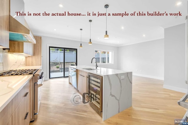 kitchen featuring high end range, light stone counters, beverage cooler, and sink