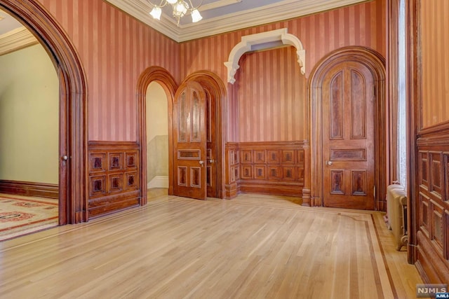 interior space with wood-type flooring and ornamental molding