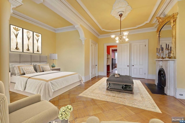 bedroom with ornate columns, parquet floors, ornamental molding, and an inviting chandelier