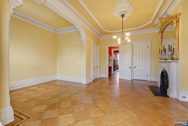 interior space featuring a chandelier, crown molding, and light parquet flooring