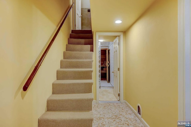 stairs featuring tile patterned floors