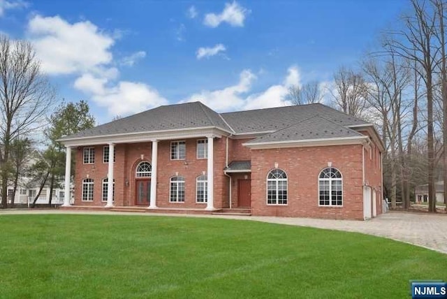 view of front of property with a garage and a front lawn