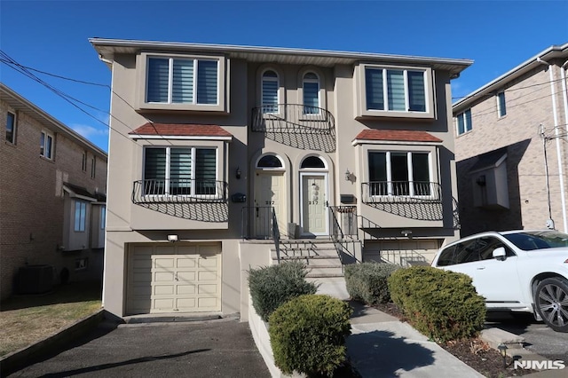 multi unit property with a garage and central AC unit