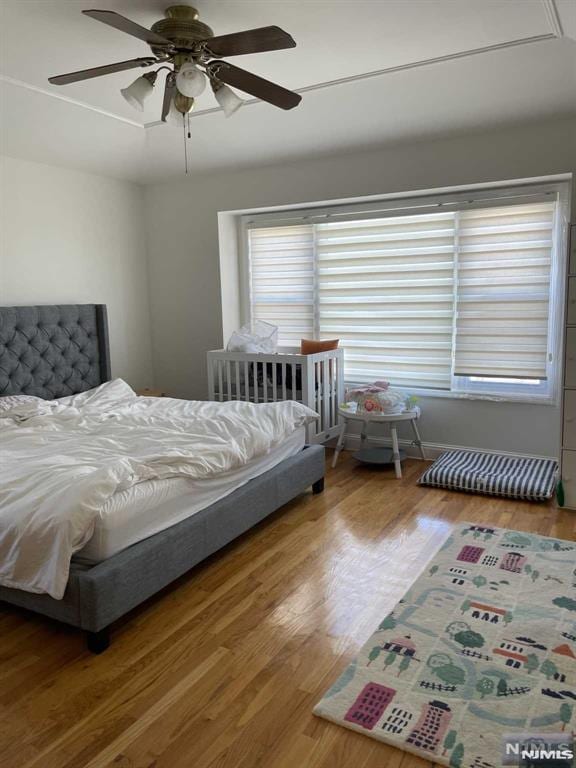 bedroom featuring hardwood / wood-style floors and ceiling fan