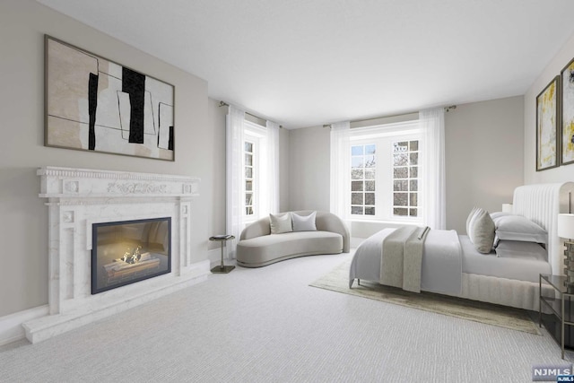 carpeted bedroom with a fireplace