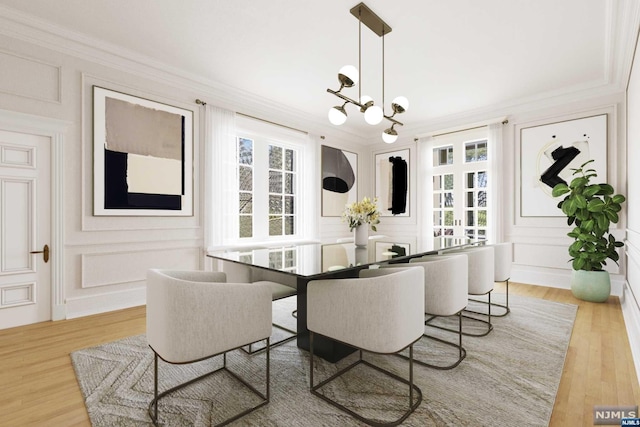 dining room with a healthy amount of sunlight, light wood-type flooring, and crown molding