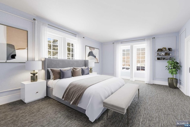 bedroom featuring dark colored carpet