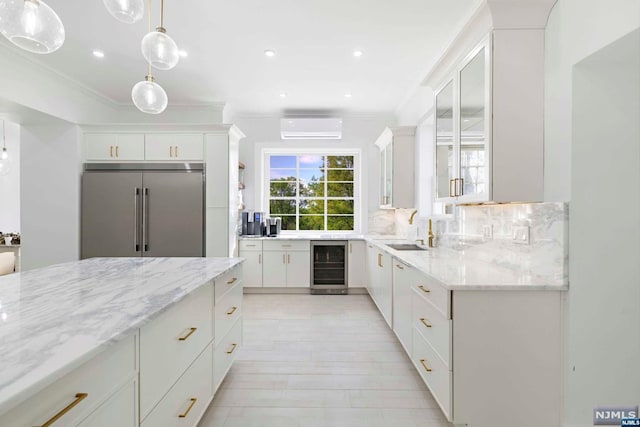 kitchen featuring a wall mounted air conditioner, tasteful backsplash, wine cooler, built in refrigerator, and white cabinets