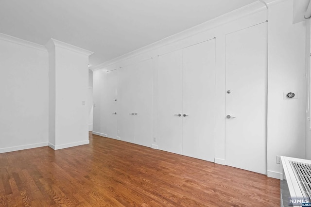 interior space featuring hardwood / wood-style floors and ornamental molding