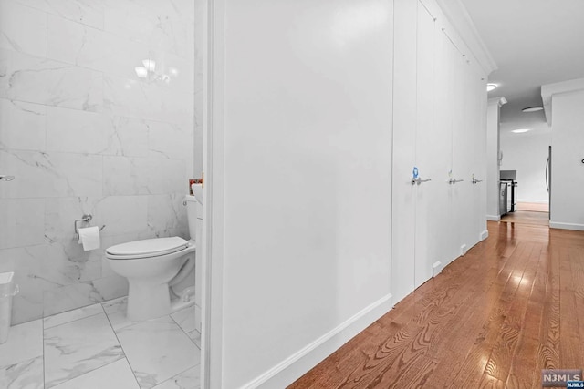 bathroom with hardwood / wood-style floors and toilet