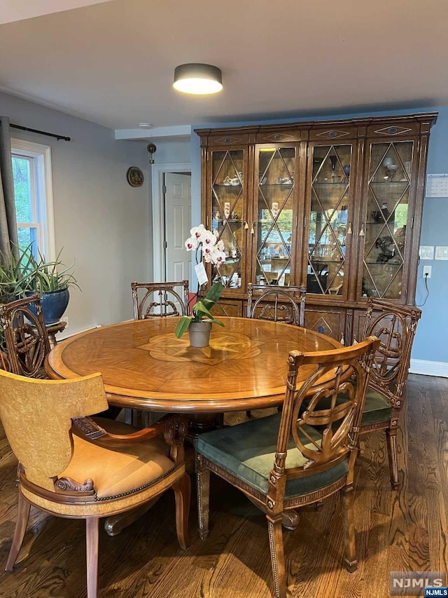 dining area with dark hardwood / wood-style floors