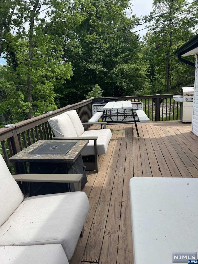 wooden terrace featuring outdoor lounge area