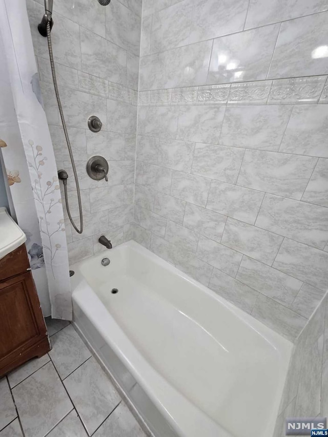 bathroom featuring vanity and shower / bath combo with shower curtain