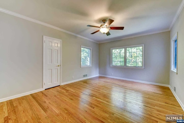 empty room featuring crown molding, ceiling fan, and light wood-type flooring