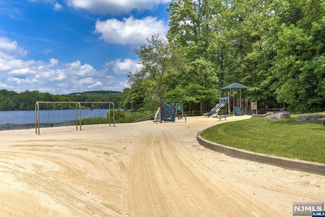 exterior space featuring a water view and a playground