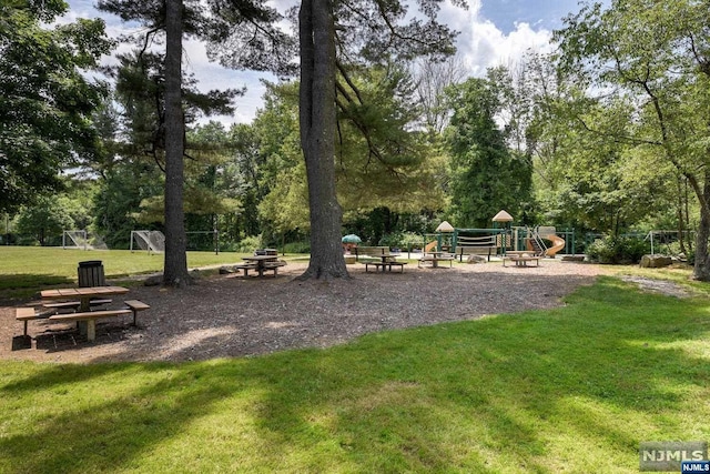 view of home's community featuring a yard and a playground