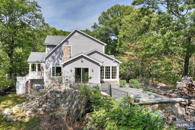 back of property featuring a wooden deck