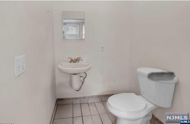 bathroom with sink, tile patterned flooring, and toilet