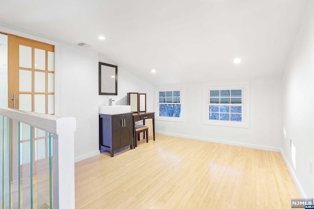 interior space featuring light hardwood / wood-style floors and lofted ceiling