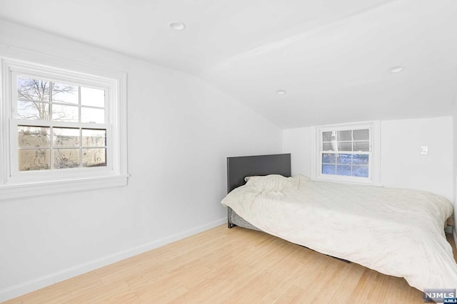 bedroom featuring lofted ceiling and wood-type flooring