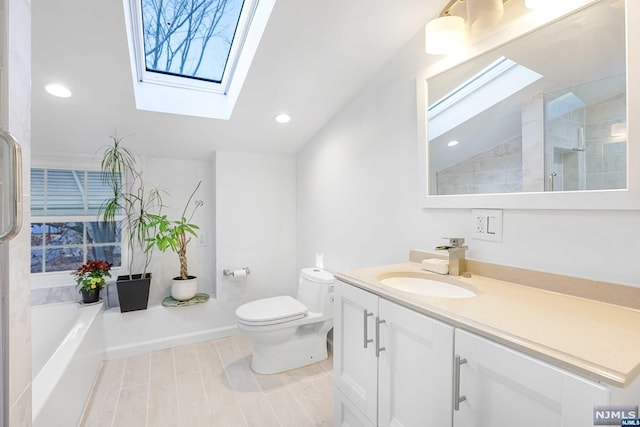 full bathroom with vaulted ceiling with skylight, vanity, separate shower and tub, and toilet