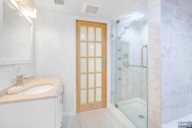 bathroom with vanity and walk in shower