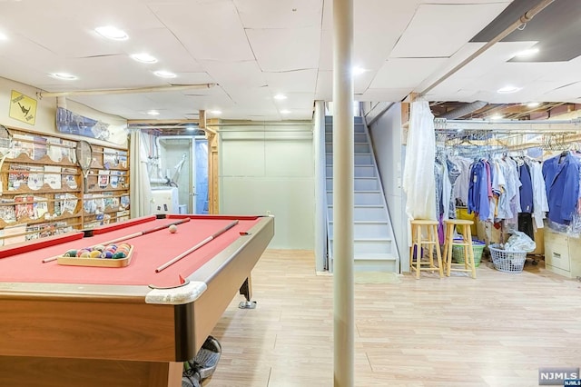 game room with independent washer and dryer, pool table, and light hardwood / wood-style flooring