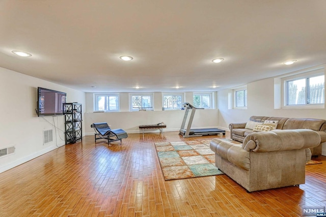 living room with a wealth of natural light and hardwood / wood-style flooring