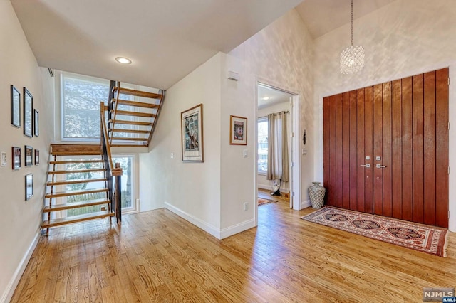 foyer featuring a chandelier and light wood-type flooring