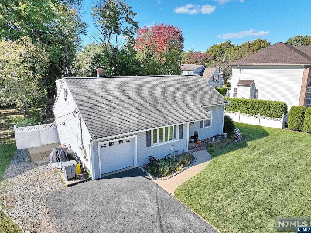 view of front facade with a front yard and a garage