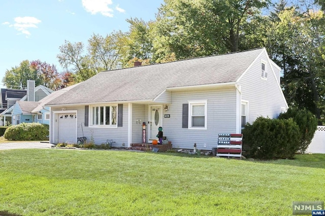 view of front facade with a garage and a front lawn