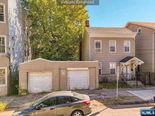 townhome / multi-family property featuring an outbuilding and a garage